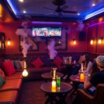 Cozy hookah lounge with colorful cushions and shisha pipes.