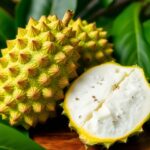 Fresh soursop fruit with green spiky skin and white flesh.