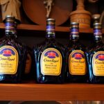 Bottles of Blackberry Crown Royal on a bar shelf.