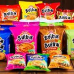 Various packs of Buldak Ramen on a wooden table.